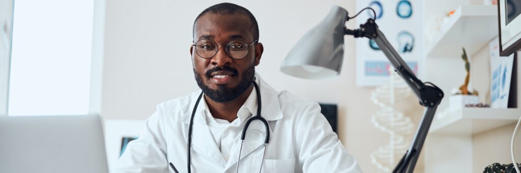 Physician with a stethoscope at his workplace