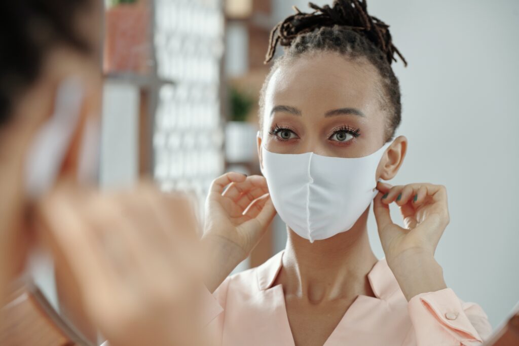 Woman Adjusting Medical Mask