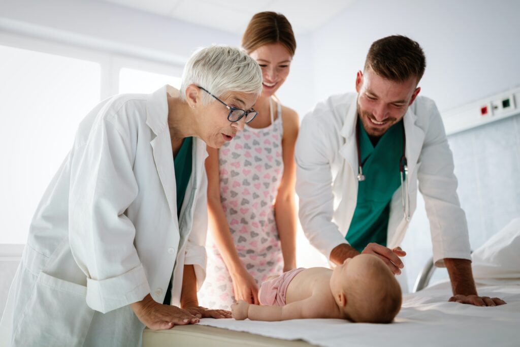 Happy beautiful mother and little baby on medical examination in pediatrician office